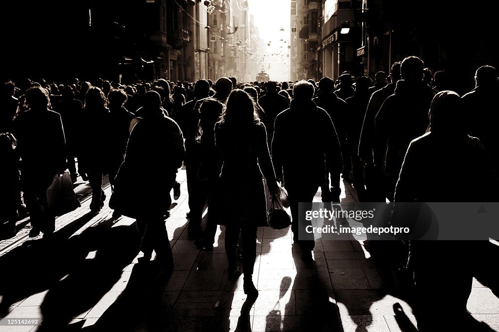 Crowded people walking on busy street