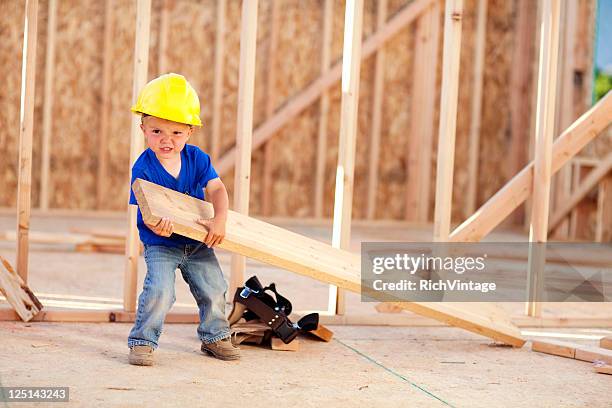 heavy labor - boy in hard hat stock pictures, royalty-free photos & images