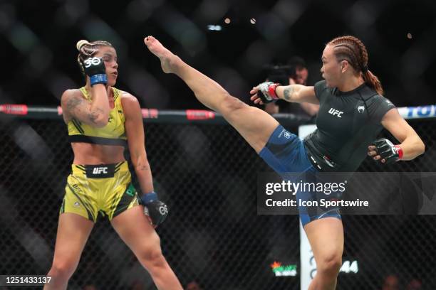 Michelle Waterson kicks Luana Pinheiro in their women strawweight fight during the UFC 287 event on April 8 at the Kaseya Center in Miami, FL.