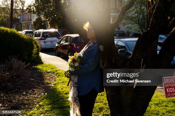 Kim Shaver holds flowers at a vigil at Crescent Hill Presbyterian Church following the mass shooting at the Old National Bank on April 10, 2023 in...
