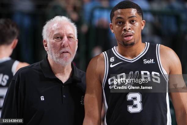 Head Coach Gregg Popovich and Keldon Johnson of the San Antonio Spurs look on during the game against the Dallas Mavericks on February 23, 2023 at...