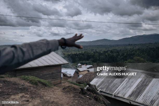 Man points toward an area of the Virunga National Park historically occupied by hutu militias, on the outskirts of Kishishe, eastern Democratic...