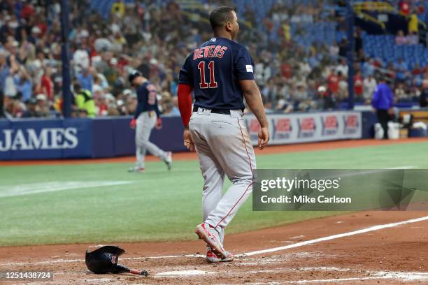 Rafael Devers of the Boston Red Sox reacts after striking out with the bases loaded in the eighth inning of a baseball game against the Tampa Bay...