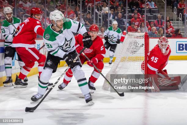 Tyler Seguin of the Dallas Stars looks to pass the puck in front of Olli Maatta of the Detroit Red Wings during the second period of an NHL game at...