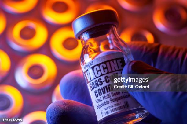 covid-19 vaccine - medical injection vials: hand holding, close-up and colorful - covid 19 vaccine stock pictures, royalty-free photos & images