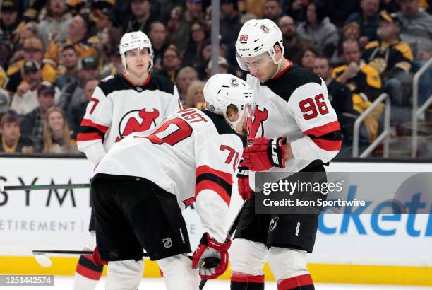 New Jersey Devils winger Jesper Boqvist and left wing Timo Meier discuss a play during a game between the Boston Bruins and the New Jersey Devils on...