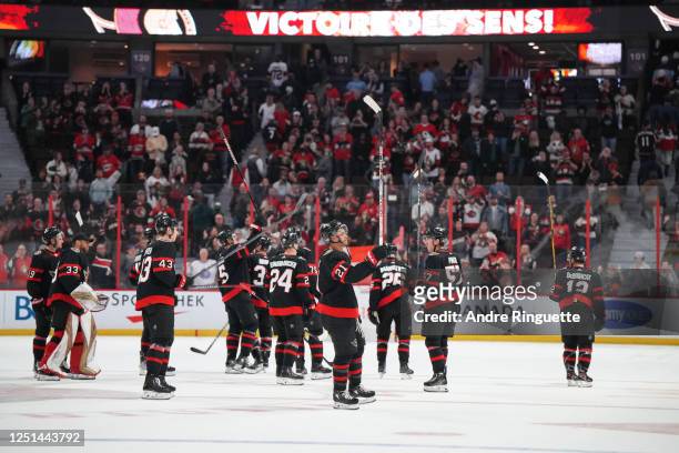 Mathieu Joseph of the Ottawa Senators raises his stick to salute the fans after a 3-2 win over the Carolina Hurricanes at Canadian Tire Centre on...