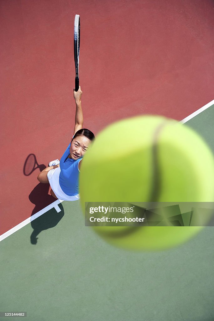 Tossing tennis ball and serve