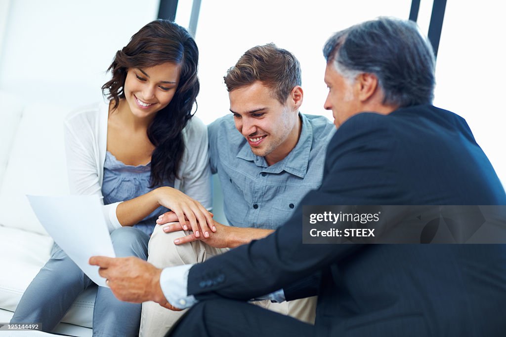 Couple discussing finances with agent