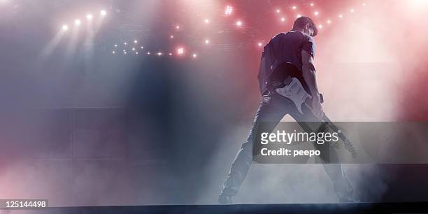 rock star with guitar - rock music stock pictures, royalty-free photos & images
