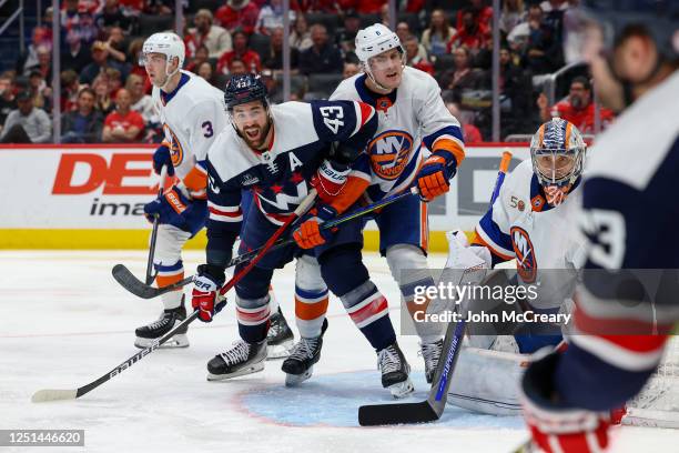 Tom Wilson of the Washington Capitals fights for a position in front of Ilya Sorokin of the New York Islanders during a game at Capital One Arena on...
