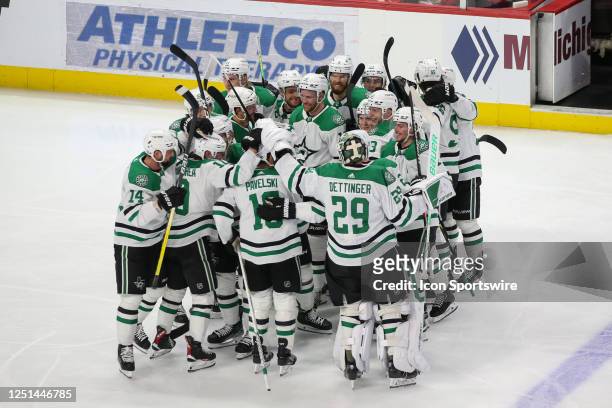 Dallas Stars forward Joe Pavelski , center, celebrates scoring a goal for his 1,000th career point with his teammates during the second period of an...