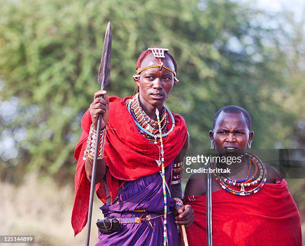 two young maasai warriors with spears and traditional dress. - masai warrior stockfoto's en -beelden