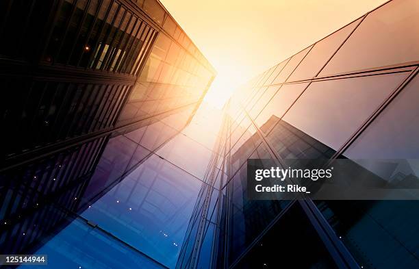 modern building side made of glass reflecting sunlight - city below stock pictures, royalty-free photos & images