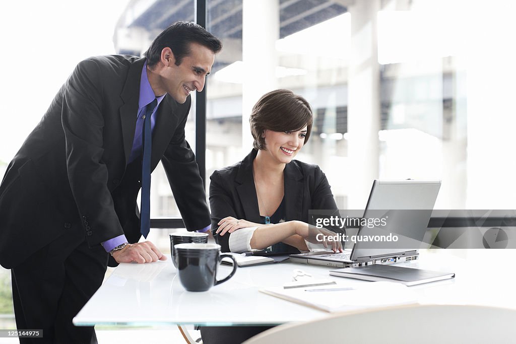 Business Coworkers Using Laptop During Meeting in Glass Office, Copyspace