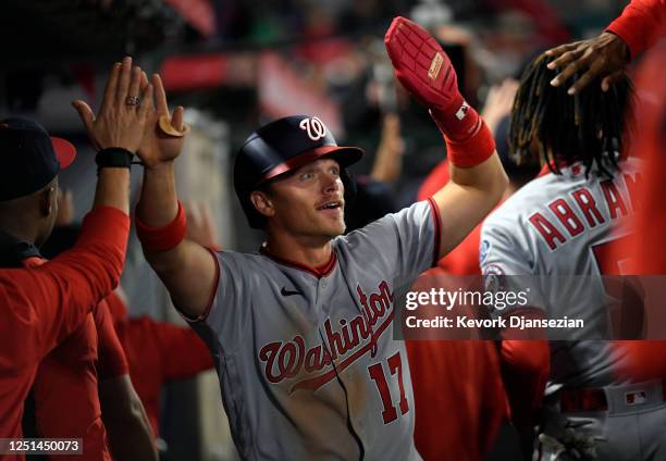 Alex Call of the Washington Nationals is congratulated in the dugout after scoring a run on a two run single by Jeimer Candelario of the Washington...