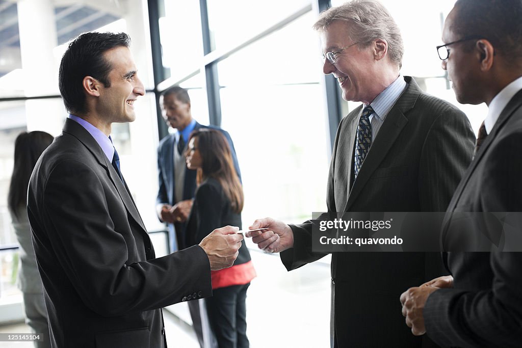Businessmen at Networking Event Exchanging Business Cards