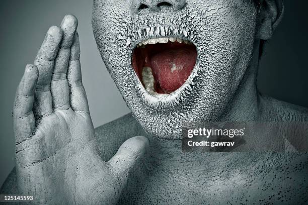 close-up, chapped, dry painted human face screaming with open mouth - human mouth stock pictures, royalty-free photos & images