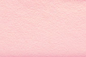 Fine grain pink woolen felt. Texture background. Velvet scarlet matte background of suede fabric