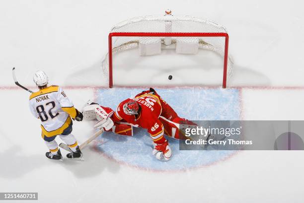 Thomas Novak of the Nashville Predators scores the game winner in the shootout against the Calgary Flames at Scotiabank Saddledome on April 10, 2023...