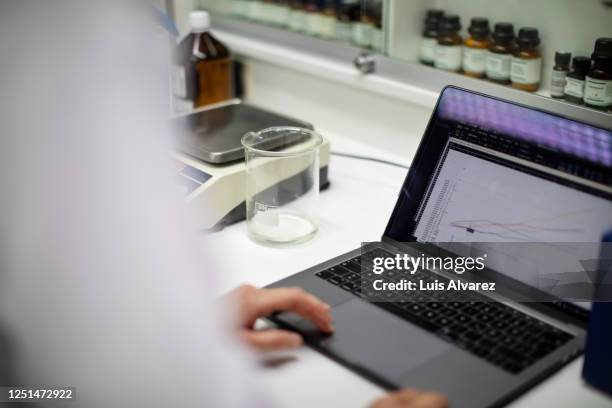 scientist analyzing experimental results on a laptop - health epidemic stock pictures, royalty-free photos & images