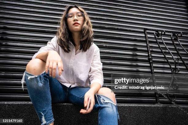 confident taiwanese teenage girl sitting on steps - street fashion asian stock pictures, royalty-free photos & images