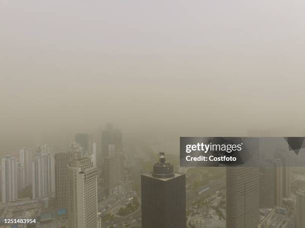 City buildings shrouded in sand and dust are seen in Huai 'an City, Jiangsu Province, China, April 11, 2023.