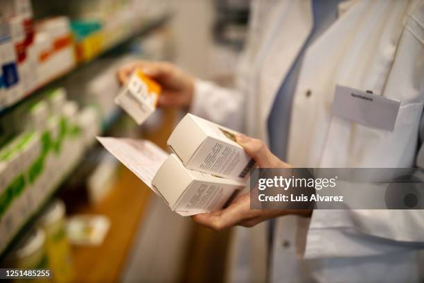 close-up of pharmacist searching prescription medicine - drug bust stock pictures, royalty-free photos & images