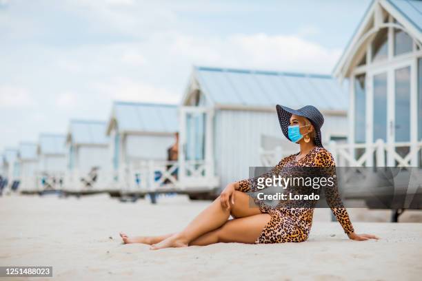 beautiful mixed race woman on the beach during covid-19 - animal pattern stock pictures, royalty-free photos & images
