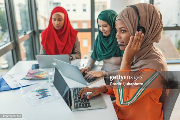 beautiful businesswoman with headset talking with a client in customer service centre. - interpret stock pictures, royalty-free photos & images