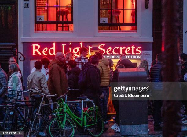 Tourists along the Oudezijds Achterburgwal canal in the red light district in Amsterdam, Netherlands, on Sunday, April 9, 2023. Amsterdam is...