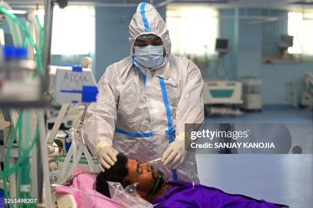 Health workers take part in a mock drill to check preparations for the Covid-19 coronavirus facilities at a hospital in Prayagraj on April 11, 2023.