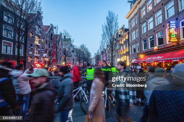 Police patrol along the Oudezijds Achterburgwal canal in the red light district in Amsterdam, Netherlands, on Sunday, April 9, 2023. Amsterdam is...