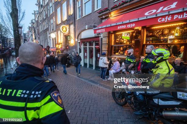 Police patrol along the Oudezijds Achterburgwal canal in the red light district in Amsterdam, Netherlands, on Sunday, April 9, 2023. Amsterdam is...