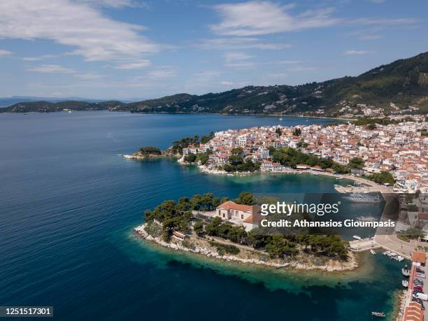 Aerial view of Bourtzi and Skiathos town on June 13, 2020 in Skiathos, Greece. Bourtzi is a tiny peninsula that divides the Skiathos port into two...