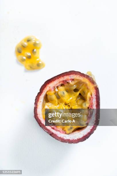 halved passionfruit on white background - passievrucht stockfoto's en -beelden