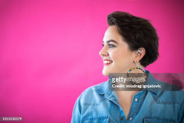 portrait of happy young woman - earring stud stock pictures, royalty-free photos & images