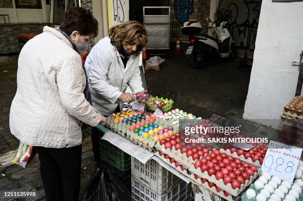 Customer buys colorful eggs at the market on April 11, 2023 in Thessaloniki, ahead of the Orthodox Easter celebrations. - Every year Greeks celebrate...