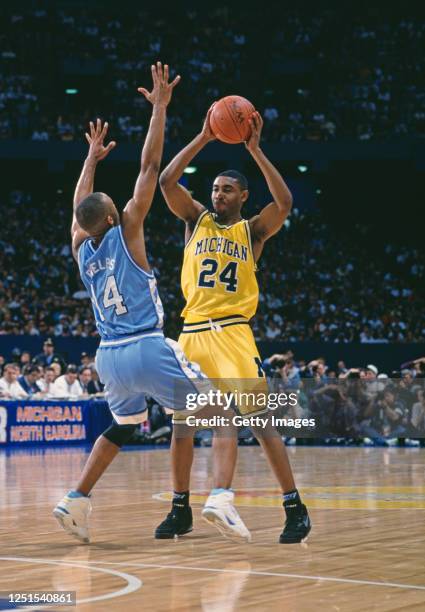 Jimmy King, Guard for the University of Michigan Wolverines and Derrick Phelps, Guard for the University of North Carolina Tar Heels during their...