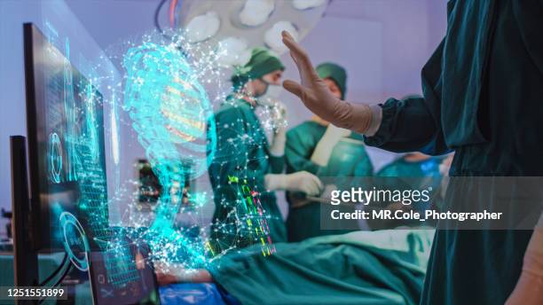 doctor using hologram modern virtual screen interface respiratory system in the operating room, innovative and future of medical and healthcare technology - healthcare and medicine stock-fotos und bilder