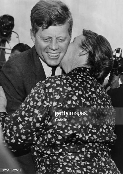 President John Fitzgerald Kennedy is kissed by his Irish cousin Mary Ryan during his visit in Dunganstown, County Wexford, on June 28, 1963. AFP PHOTO