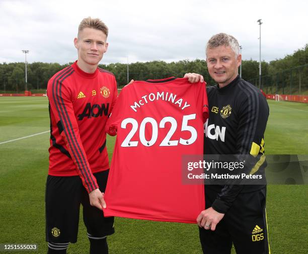 Scott McTominay of Manchester United poses with Manager Ole Gunnar Solskjaer after signing a new contract after a first team training session at Aon...