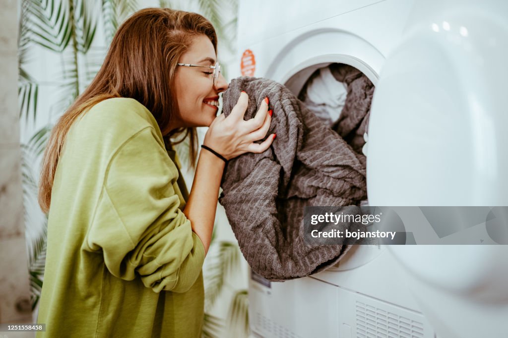 Young woman doing her laundry at home