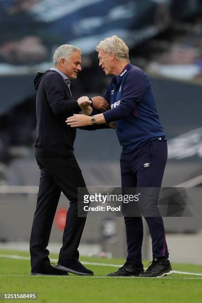 Jose Mourinho, Manager of Tottenham Hotspur and David Moyes, Manager of West Ham United interact prior to the Premier League match between Tottenham...