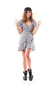 Eager hyped expressive cute stylish young woman in summer dress with raised hands