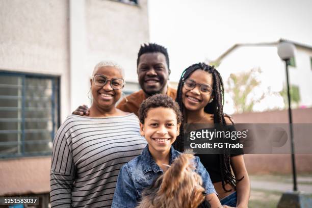 portrait of a family with two children - humility stock pictures, royalty-free photos & images
