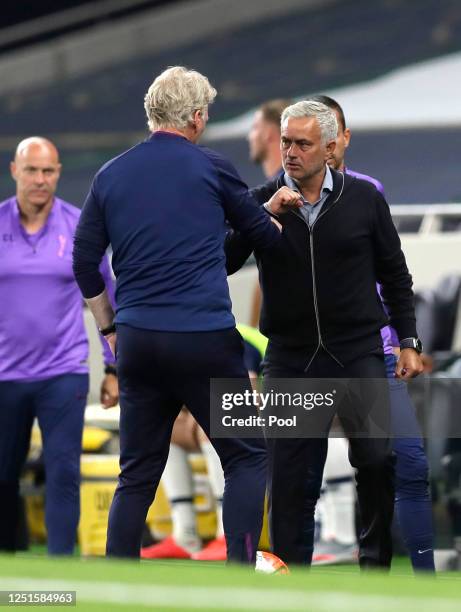 David Moyes, Manager of West Ham United and Jose Mourinho, Manager of Tottenham Hotspur interacts following the Premier League match between...