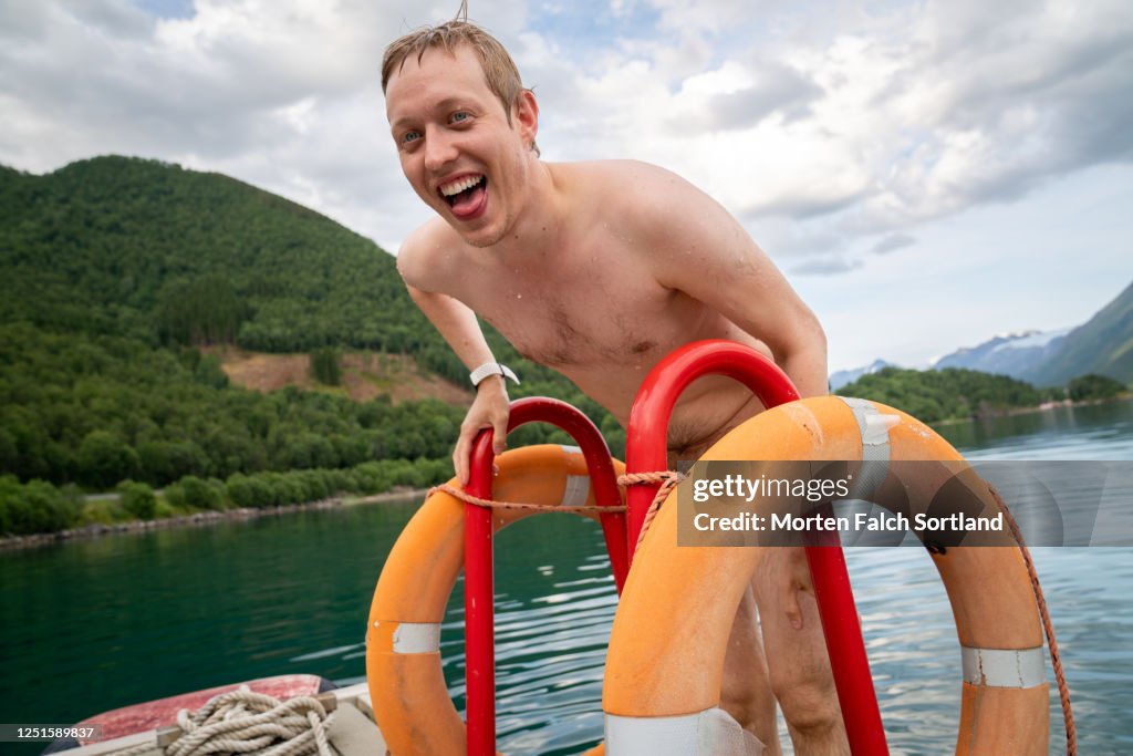 A Caucasian man holding on to a railing in Halsa, Norway