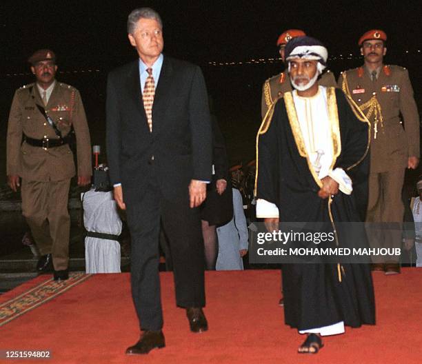 Sultan Qaboos of Oman escorts US President Bill Clinton upon his arrival 25 March 2000 to Oman airport. Clinton made a stopover in Oman on his way to...
