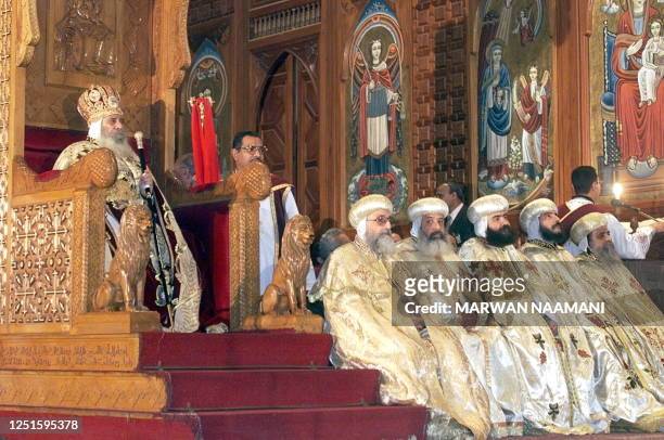 Egyptian Pope Shenouda III and Coptic priests attend midnight mass 07 January 2000, at Cairo's Saint Murkos church. The death of 18 Copts during...